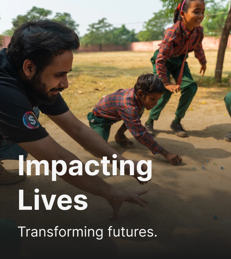 Adult man wearing black t-shirt playing marbles with school kinds with an overlaid text "Impacting lives transforming futures".